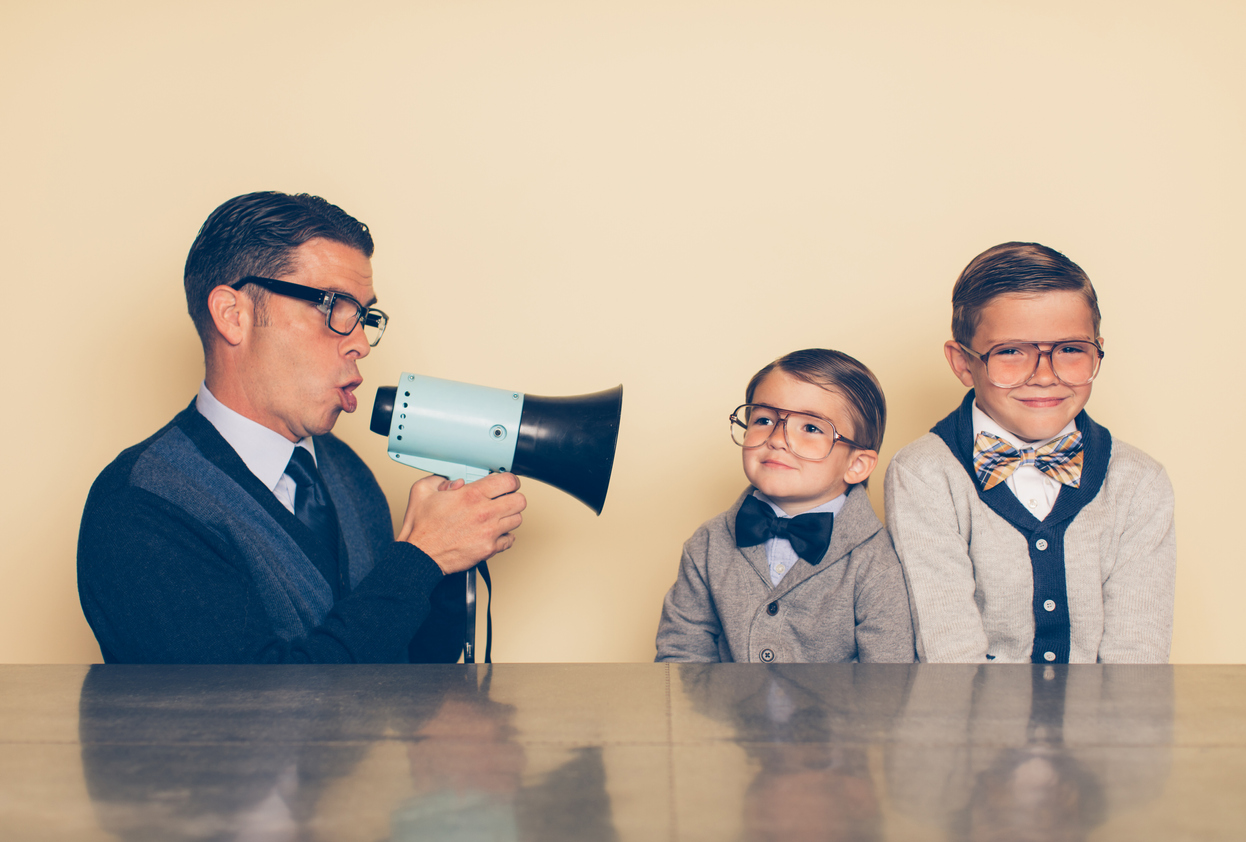 Male salesperson using a megaphone and salesy behaviors to reach to prospective customers.